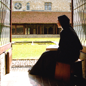 Nun praying in the cloister